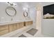 Bright bathroom featuring a dual vanity with modern fixtures and stylish hexagon tile flooring at 1712 E Fairfield St, Mesa, AZ 85203
