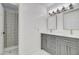 A modern bathroom featuring dual vanities and a shower at 1712 E Fairfield St, Mesa, AZ 85203