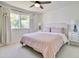 Bright bedroom with a ceiling fan and a light pink bed at 1712 E Fairfield St, Mesa, AZ 85203