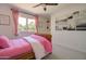 A charming bedroom with a decorative wood bedframe, lovely pink curtains, and an airy feel at 1712 E Fairfield St, Mesa, AZ 85203