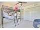 A stylish bedroom featuring a bunk bed with storage, ladder and comfortable seating at 1712 E Fairfield St, Mesa, AZ 85203