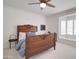 Comfortable bedroom with a ceiling fan, bay window seat, and carved wooden bed frame at 1712 E Fairfield St, Mesa, AZ 85203