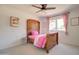 A charming bedroom with a decorative wood bedframe and matching ceiling fan at 1712 E Fairfield St, Mesa, AZ 85203