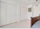 Spacious bedroom boasts neutral carpet and ample closet space behind white doors at 1712 E Fairfield St, Mesa, AZ 85203