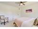 Inviting bedroom showcasing a ceiling fan and a chair with a classic, vintage design at 1712 E Fairfield St, Mesa, AZ 85203