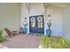 Inviting front entrance with double doors, brick pathway, potted cacti, and overhead lighting at 1712 E Fairfield St, Mesa, AZ 85203