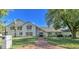 Beautiful two-story home with brick walkway, mature landscaping, and a white painted brick exterior at 1712 E Fairfield St, Mesa, AZ 85203