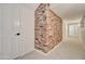 Bright hallway with a brick accent wall and white trim at 1712 E Fairfield St, Mesa, AZ 85203