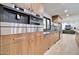 Modern kitchen featuring wood cabinetry, stainless steel appliances, and stone countertops at 1712 E Fairfield St, Mesa, AZ 85203