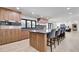 Gourmet kitchen with marble countertops, wood cabinets, a built-in oven and seating for four at 1712 E Fairfield St, Mesa, AZ 85203