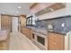 Modern kitchen with wood cabinets, stainless steel appliances, and stone countertop at 1712 E Fairfield St, Mesa, AZ 85203