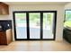 A chef's kitchen leads to an outdoor patio and large manicured backyard through folding glass doors at 1712 E Fairfield St, Mesa, AZ 85203