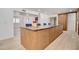 Spacious kitchen island with seating and wood cabinetry at 1712 E Fairfield St, Mesa, AZ 85203