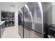 Spacious laundry room with stainless steel appliances and stacked washer dryer at 1712 E Fairfield St, Mesa, AZ 85203