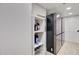 Laundry room with shelving and stainless steel refrigerator at 1712 E Fairfield St, Mesa, AZ 85203