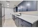 A modern laundry room with navy cabinets and stainless steel appliances at 1712 E Fairfield St, Mesa, AZ 85203
