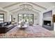 Bright living room features vaulted ceiling, fireplace, and large picture window with a view of the backyard at 1712 E Fairfield St, Mesa, AZ 85203