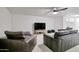 Carpeted living room with comfortable seating area and entertainment center at 1712 E Fairfield St, Mesa, AZ 85203