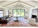 Bright living room features vaulted ceiling, fireplace, and large picture window with a view of the backyard at 1712 E Fairfield St, Mesa, AZ 85203