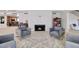 Bright living room featuring light hardwood floors, fireplace and four elegant chairs with gold trim at 1712 E Fairfield St, Mesa, AZ 85203