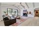 Bright living room features vaulted ceiling, fireplace, and large picture window with a view of the backyard at 1712 E Fairfield St, Mesa, AZ 85203
