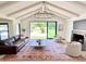 Bright living room features vaulted ceiling, fireplace, and large picture window with a view of the backyard at 1712 E Fairfield St, Mesa, AZ 85203