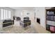 Bright living room with modern furniture, fireplace, and whitewashed hardwood flooring at 1712 E Fairfield St, Mesa, AZ 85203