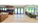 Kitchen area leading to a modern living space with open floor plan and backyard access at 1712 E Fairfield St, Mesa, AZ 85203