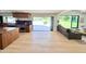 Kitchen area leading to a modern living space with open floor plan and backyard access at 1712 E Fairfield St, Mesa, AZ 85203