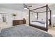 Bright main bedroom boasts a four-poster bed, a ceiling fan, and modern decor at 1712 E Fairfield St, Mesa, AZ 85203