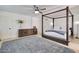 Bright main bedroom boasts a four-poster bed, a ceiling fan, and modern decor at 1712 E Fairfield St, Mesa, AZ 85203