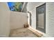 Private outdoor shower featuring stone walls, tiled flooring, wood bench and stylish shower fixtures at 1712 E Fairfield St, Mesa, AZ 85203