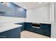 Stylish pantry with custom blue cabinetry, quartz countertops, and a built in oven at 1712 E Fairfield St, Mesa, AZ 85203