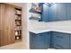 Blue pantry with built-in wooden shelving and white countertop space at 1712 E Fairfield St, Mesa, AZ 85203