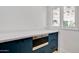 Modern pantry with custom blue cabinetry, quartz countertops and stainless steel appliances at 1712 E Fairfield St, Mesa, AZ 85203