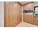 Pantry with wood cabinets and appliances including a built in microwave oven and coffee maker at 1712 E Fairfield St, Mesa, AZ 85203