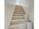 Carpeted staircase with natural light and decor baskets at 1712 E Fairfield St, Mesa, AZ 85203