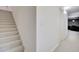 Neutral carpeted stairs lead to the lower level of this residence at 1712 E Fairfield St, Mesa, AZ 85203