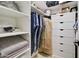 Organized walk-in closet with ample shelving, drawers, and space for hanging clothes at 1712 E Fairfield St, Mesa, AZ 85203