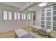 Spacious walk-in closet features built-in shelving, two benches, and mirrored doors for ample storage at 1712 E Fairfield St, Mesa, AZ 85203
