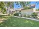 View of the home's exterior showing a well-maintained lawn, mature plantings, and a brick exterior at 1712 E Fairfield St, Mesa, AZ 85203