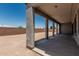 Covered back patio with concrete flooring and support beams at 17322 W Puget Ave, Waddell, AZ 85355