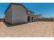 Backyard featuring stucco walls and new dirt ready for landscaping at 17322 W Puget Ave, Waddell, AZ 85355