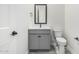 Bathroom featuring a gray vanity, black hardware, and a white toilet at 17322 W Puget Ave, Waddell, AZ 85355