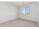 Bedroom featuring neutral walls and carpet with a large window at 17322 W Puget Ave, Waddell, AZ 85355