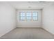 Bright bedroom featuring three windows providing ample natural light at 17322 W Puget Ave, Waddell, AZ 85355