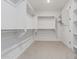 Walk-in closet with multiple shelves and hanging racks for storage at 17322 W Puget Ave, Waddell, AZ 85355