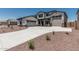 Beautiful two-story home featuring a three car garage, and a long concrete driveway at 17322 W Puget Ave, Waddell, AZ 85355