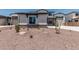 Charming two-story home featuring desert landscaping and a stone-accented facade at 17322 W Puget Ave, Waddell, AZ 85355