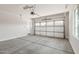 Garage with concrete floors and overhead door with windows at 17322 W Puget Ave, Waddell, AZ 85355